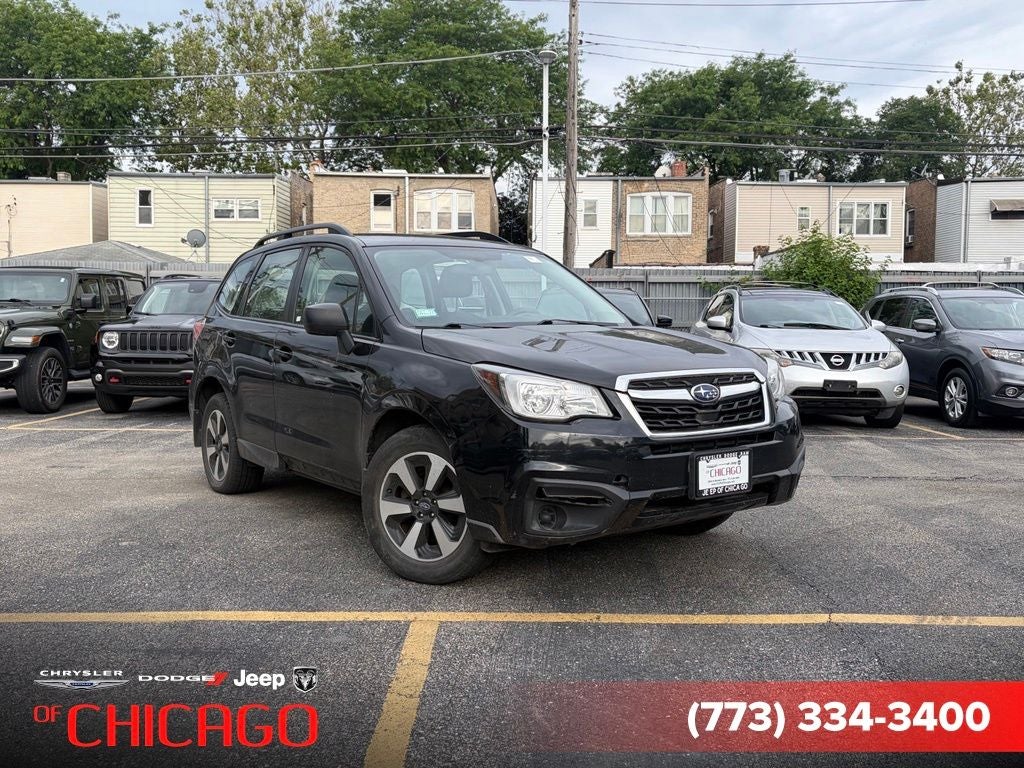 2018 Subaru Forester 2.5i in Crystal Black Silica — front three-quarter view